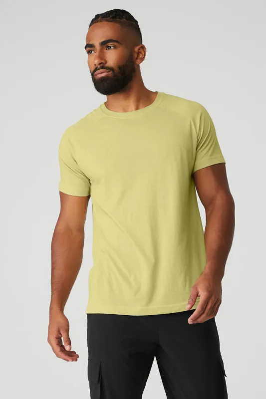 The Triumph Crew Neck Tee - Dusty Yellow sold by Alo Yoga