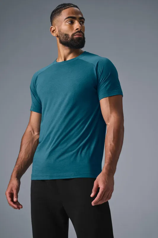 Triumph Raglan Tee - Oceanic Teal sold by Alo Yoga