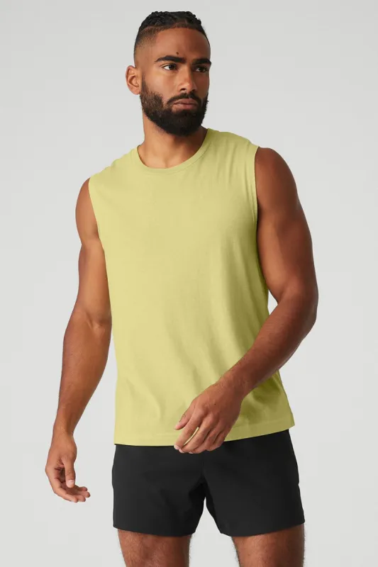 The Triumph Muscle Tank - Dusty Yellow sold by Alo Yoga