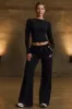Low-Rise Wide-Leg Joggers in Black sold by Bo + Tee