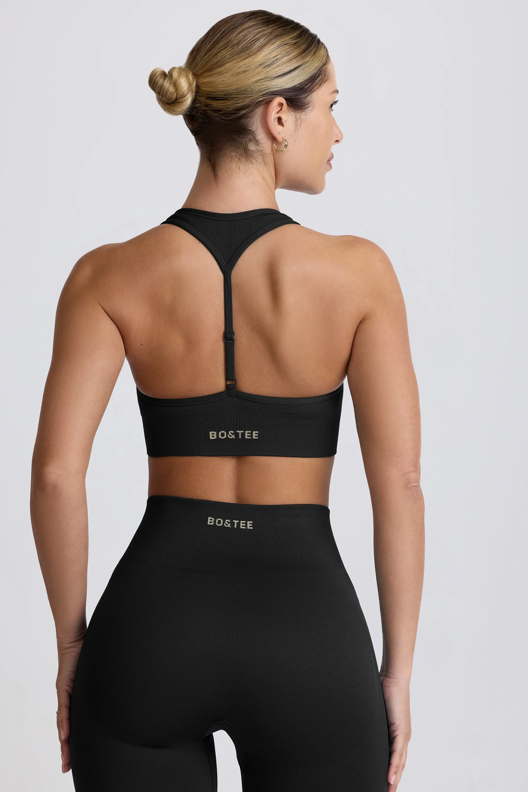 Super Sculpt Seamless T-Back Sports Bra in Black sold by Bo + Tee