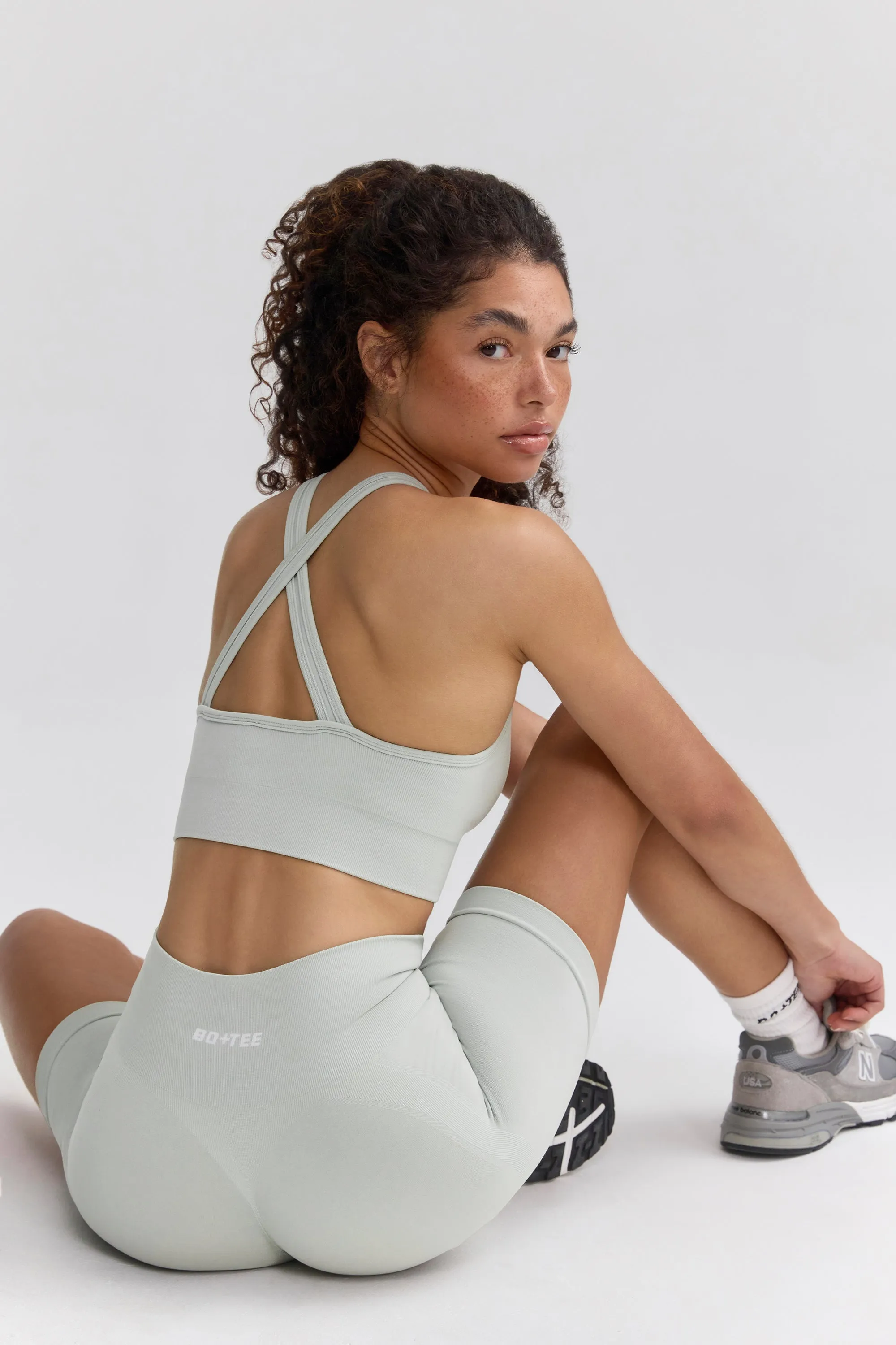 Super Sculpt Seamless Cross-Back Sports Bra in Grey sold by Bo + Tee