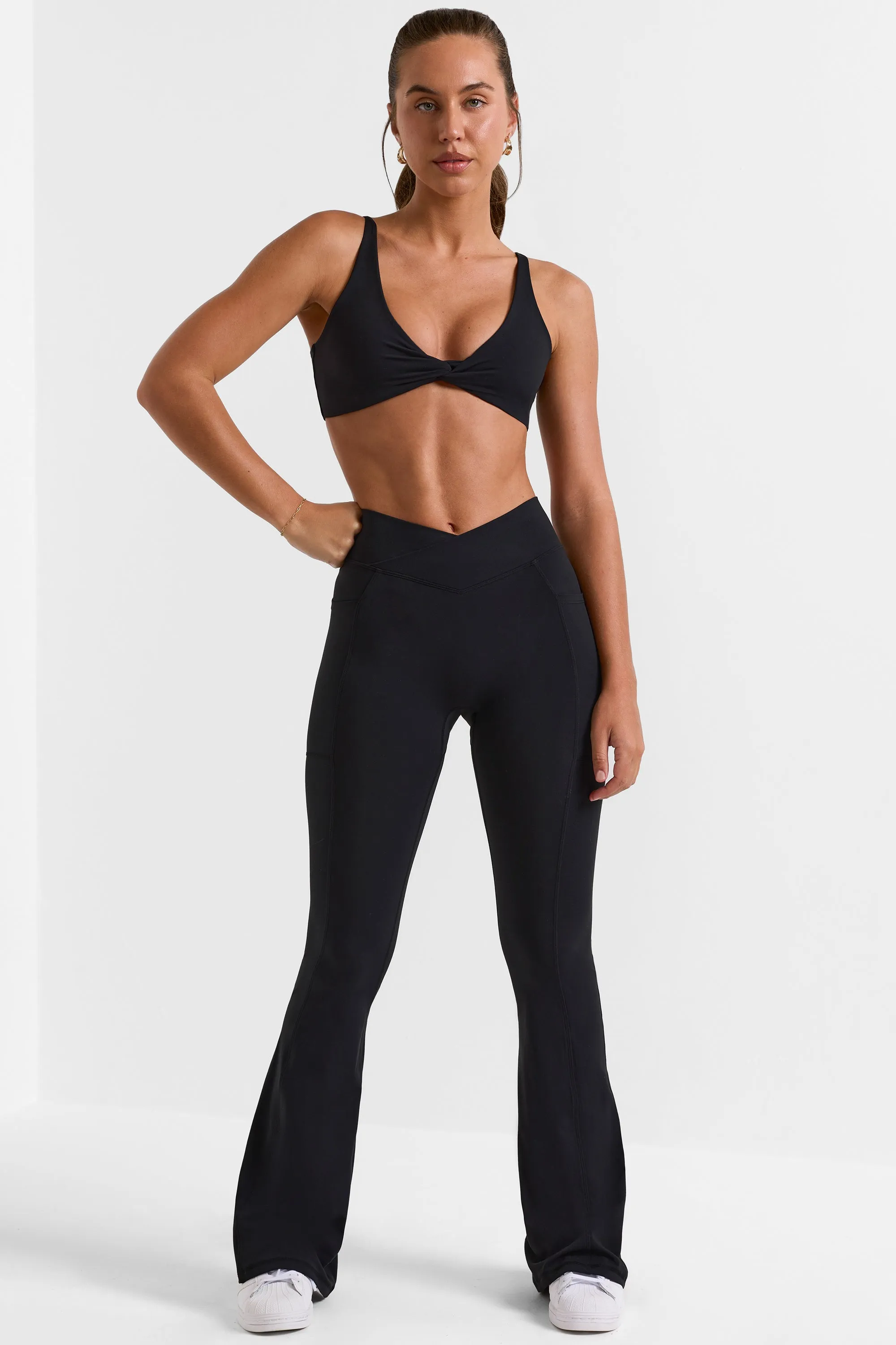 Petite Soft Active Crossover Flared Trousers in Black sold by Bo + Tee