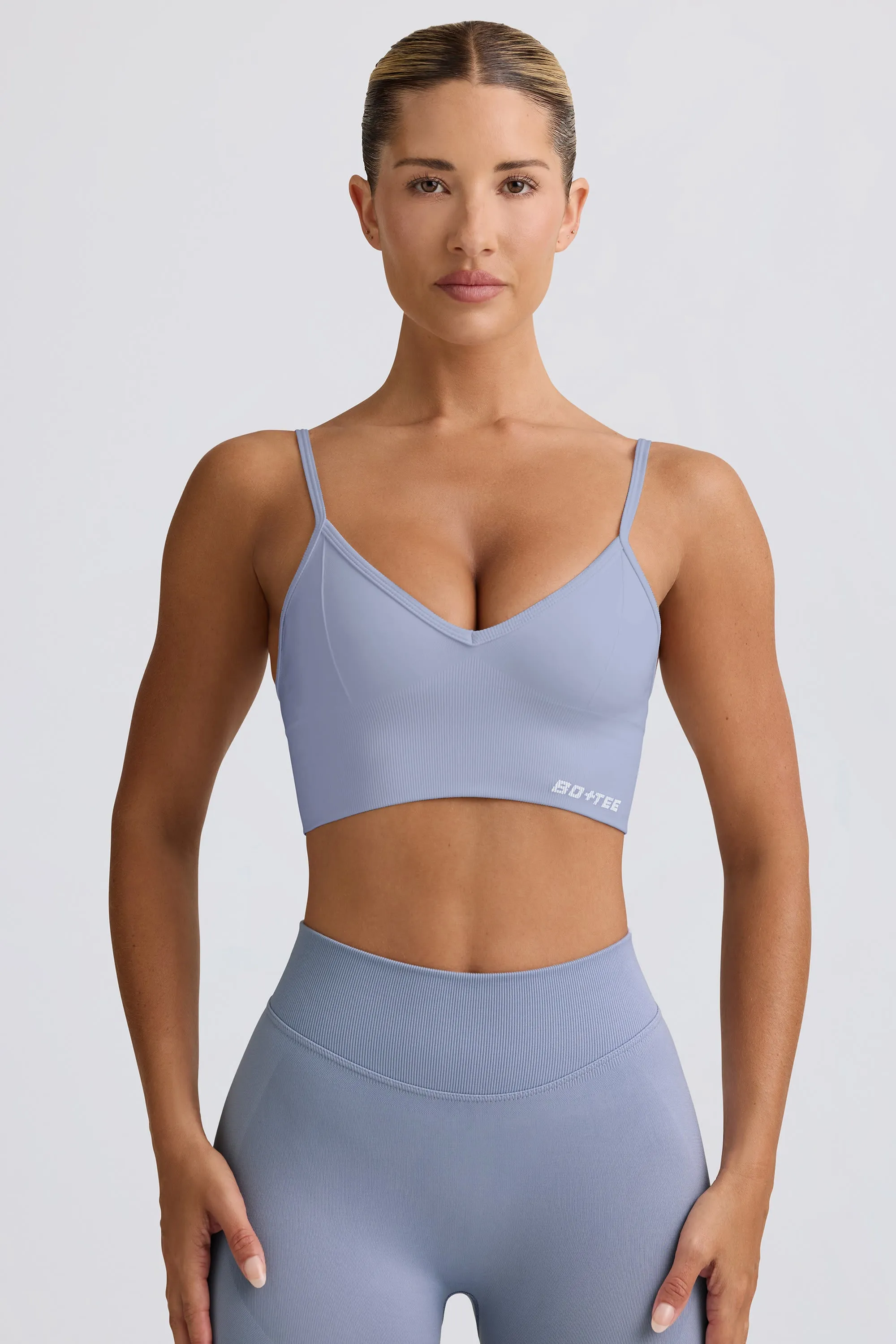 Define Luxe V-Neck Sports Bra in Blue Grey sold by Bo + Tee