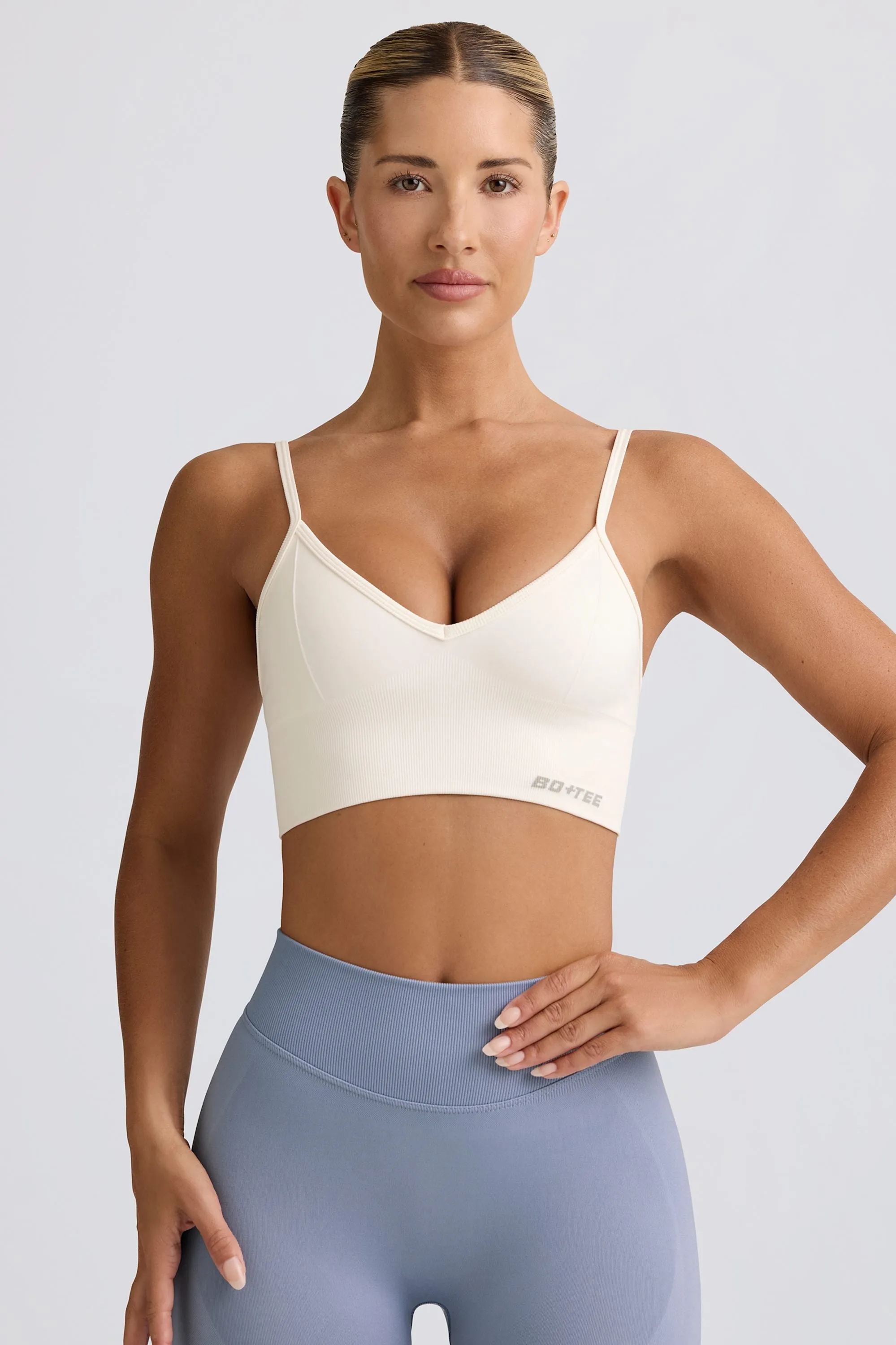 Define Luxe V-Neck Sports Bra in White sold by Bo + Tee