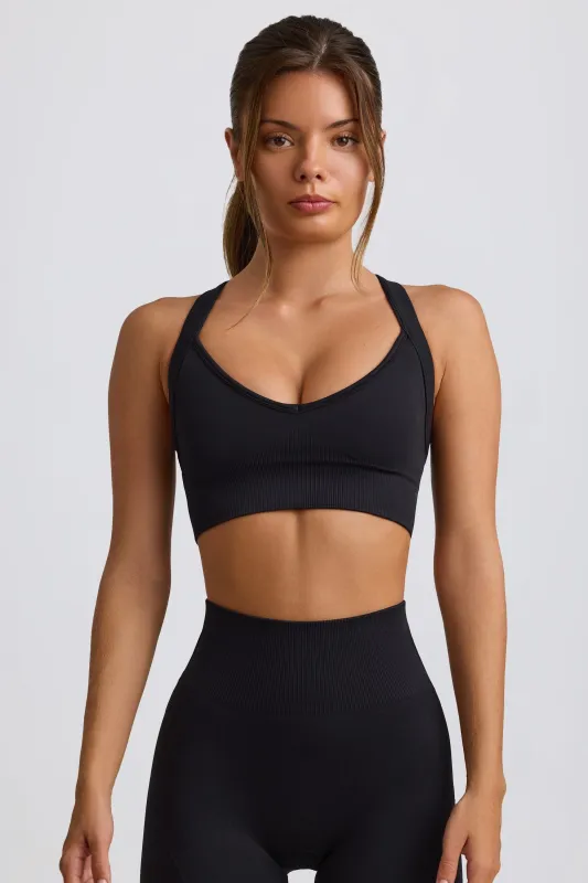 Super Sculpt Seamless Cross-Back Sports Bra in Black sold by Bo + Tee