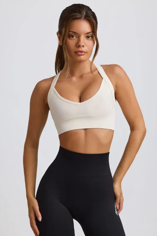 Super Sculpt Seamless Cross-Back Sports Bra in White sold by Bo + Tee