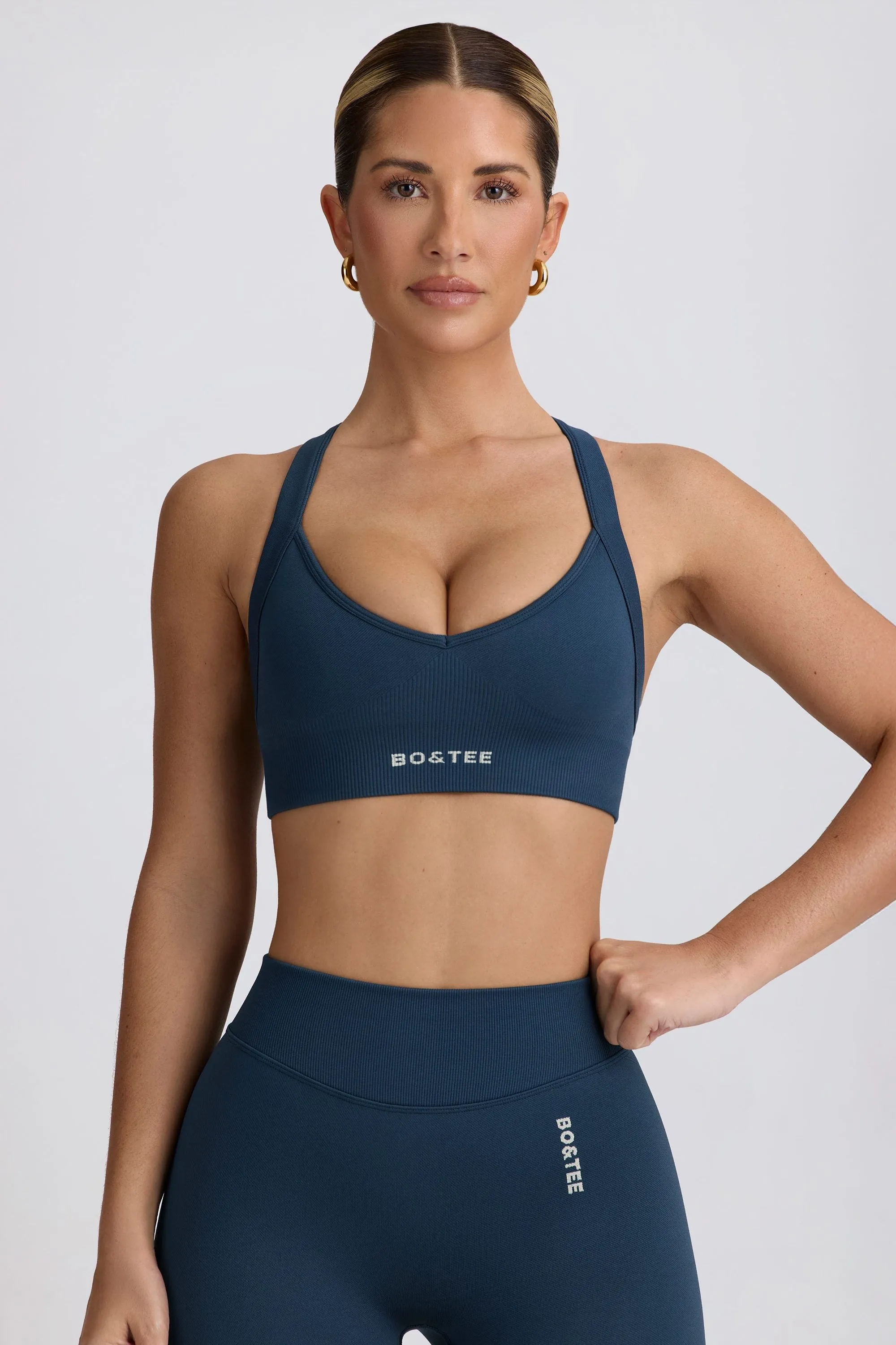 Super Sculpt Seamless Cross-Back Sports Bra in Blue sold by Bo + Tee