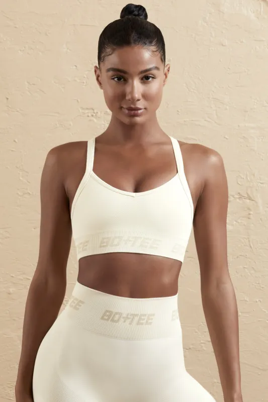 Undefeated - Cross Back Sports Bra in Cream sold by Bo + Tee