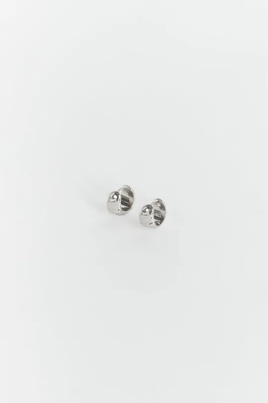 LUV AJ HAMMERED SILVER HUGGIE EARRINGS sold by Dissh