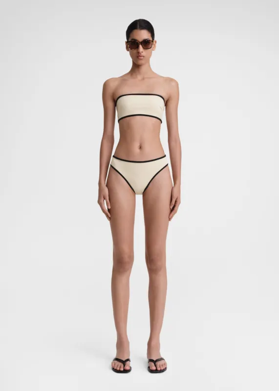 Stripe edge strapless bikini top light hay sold by Toteme