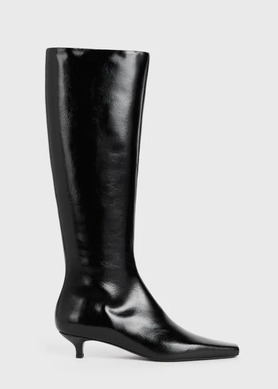 Slim patent knee-high boots black sold by Toteme