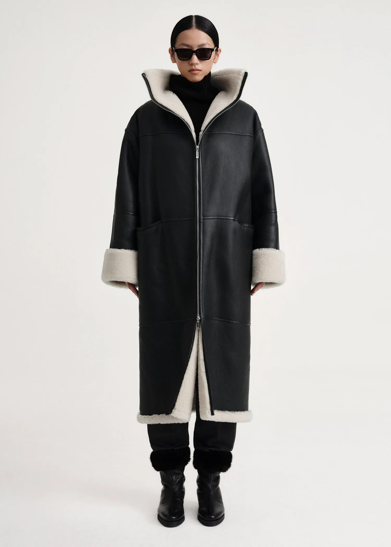 Signature shearling coat black/off-white sold by Toteme