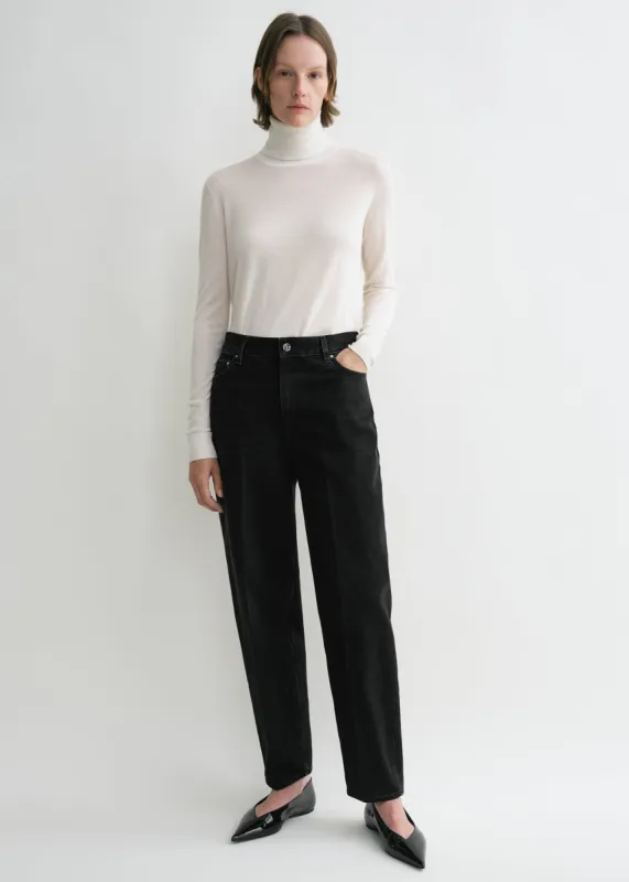 Wide tapered leg denim faded black sold by Toteme