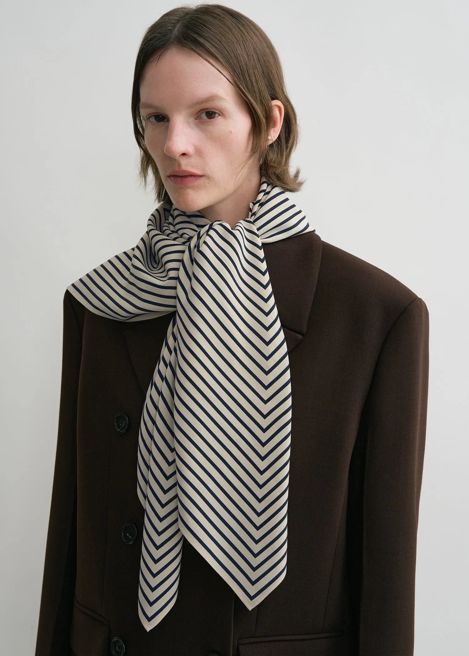 Signature monogram silk blanket scarf creme sold by Toteme