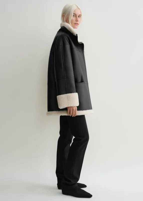Signature shearling jacket black/off-white sold by Toteme