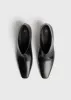 Wide shaft shoes black sold by Toteme