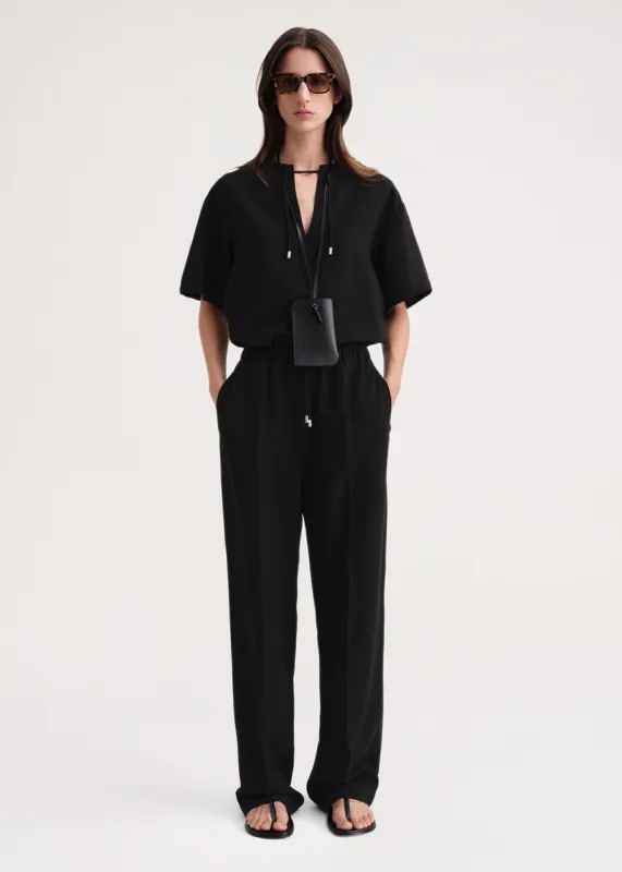 Press-creased drawstring trousers black sold by Toteme