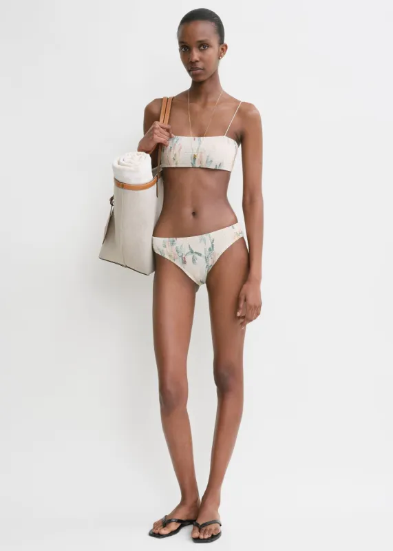 Smocked mid-rise bikini bottoms washed floral sold by Toteme