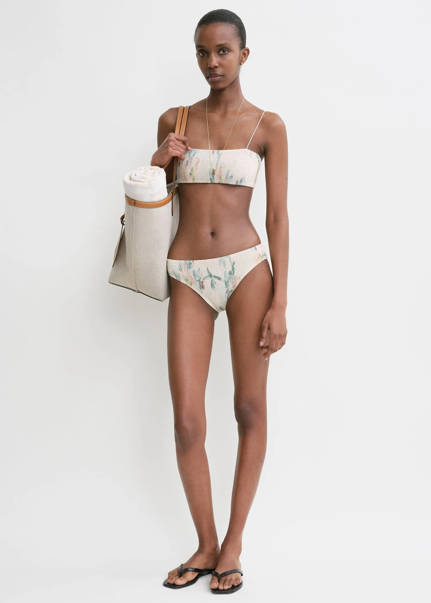 Smocked mid-rise bikini bottoms washed floral sold by Toteme