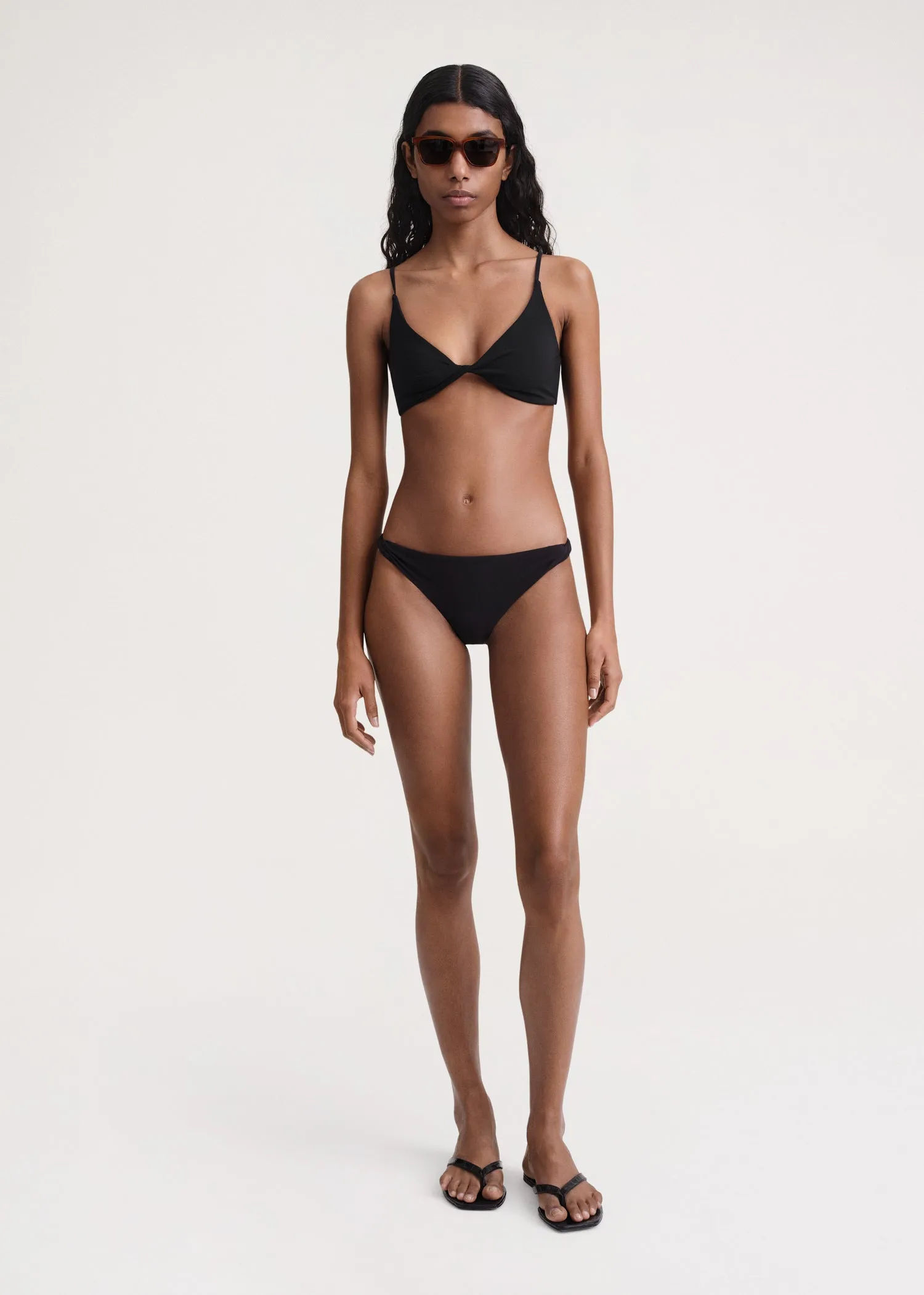 Twist-side bikini bottoms black sold by Toteme