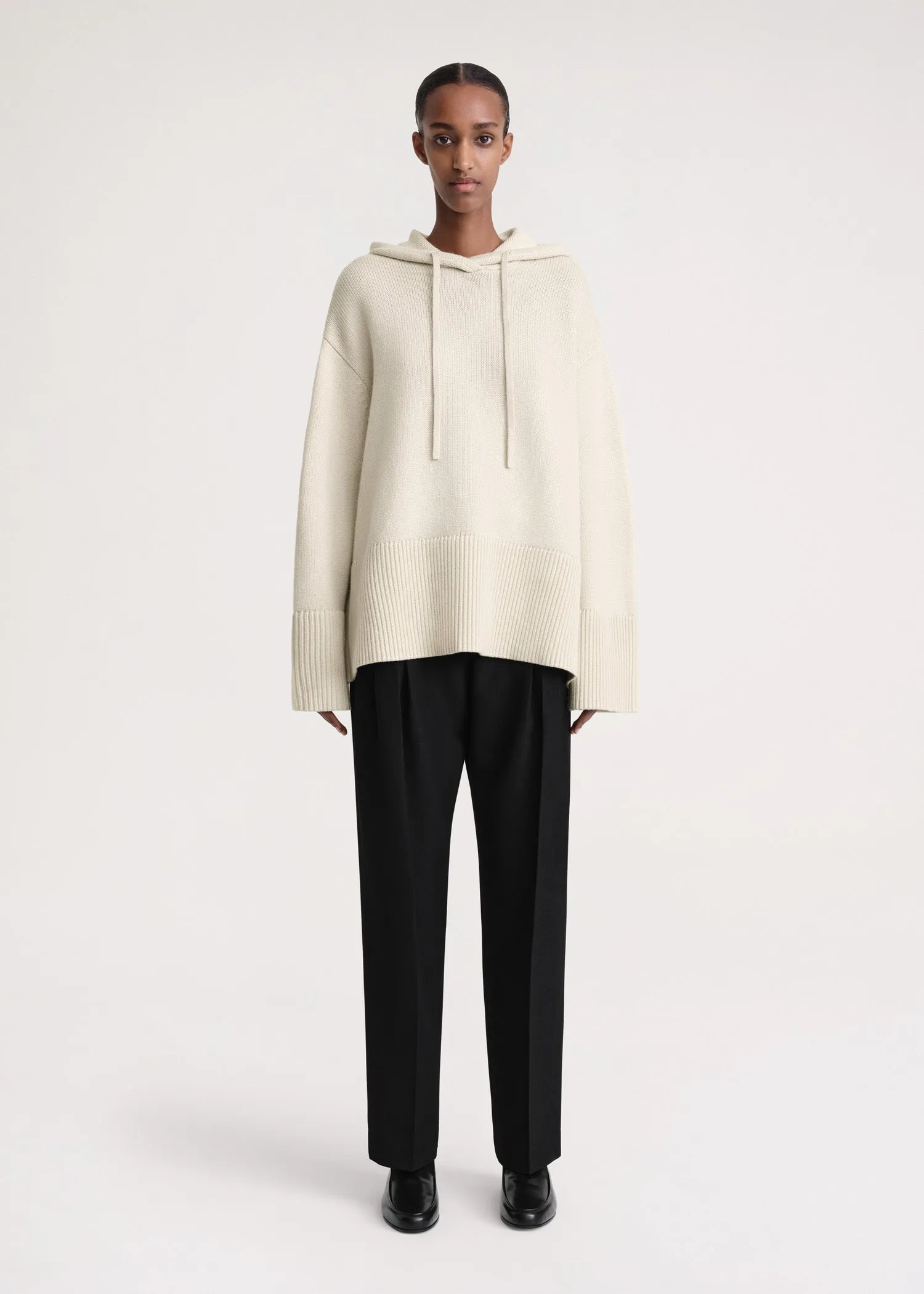 Signature hooded knit light sand sold by Toteme
