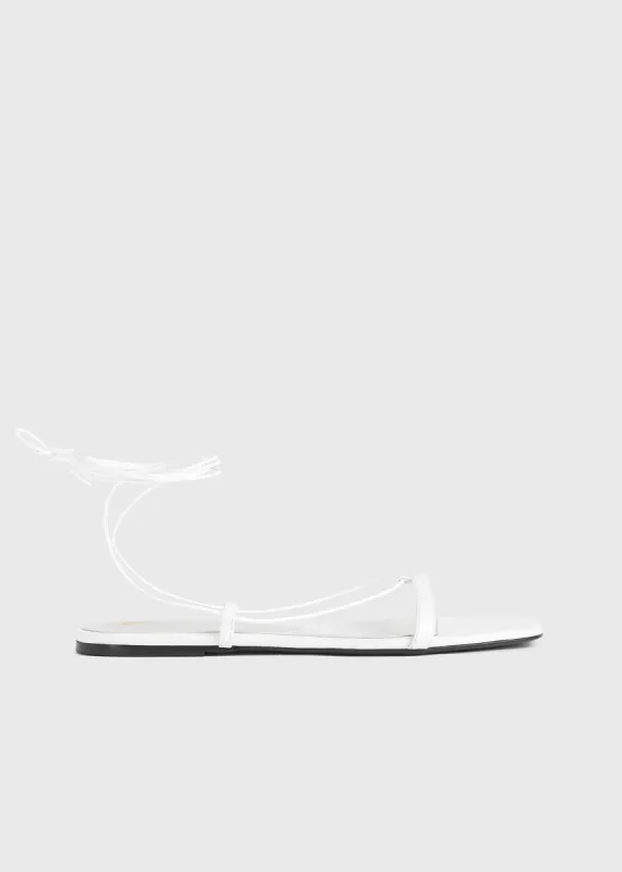 The Croco Tie Sandal white sold by Toteme