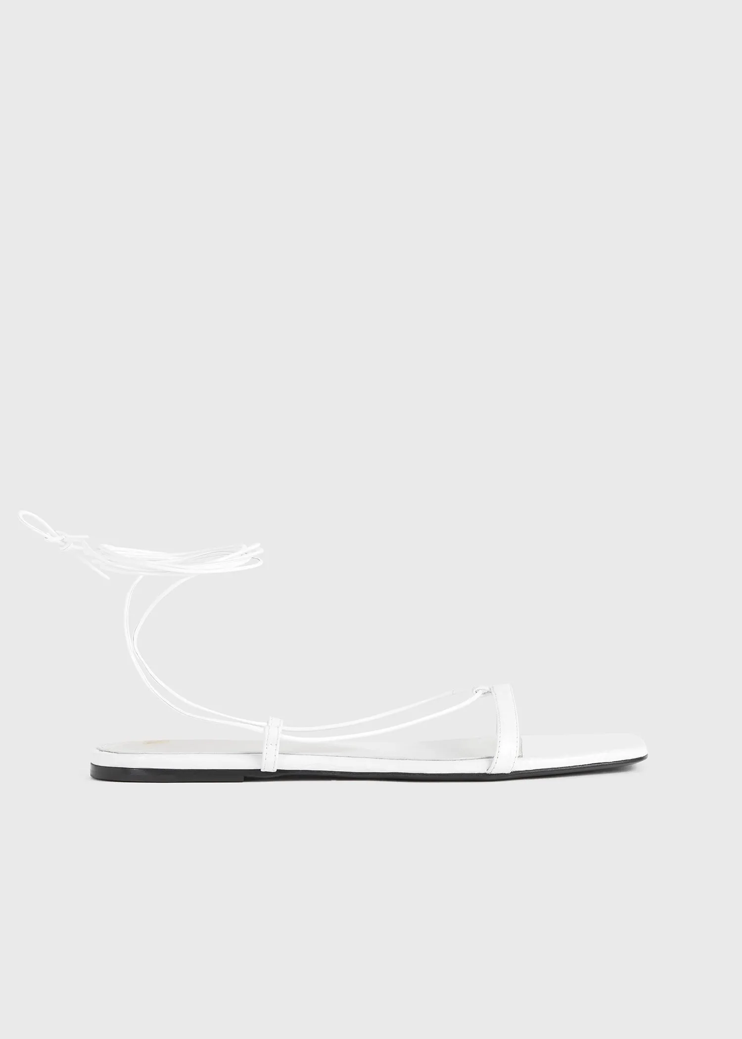 The Croco Tie Sandal white sold by Toteme