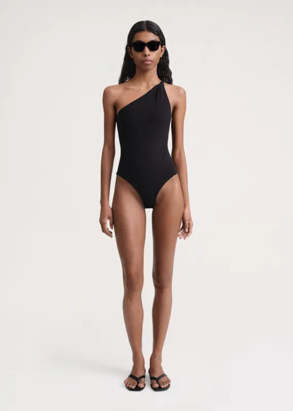 Twist-strap one-shoulder swimsuit black sold by Toteme