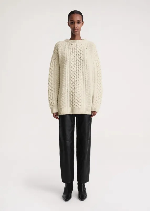 Chunky cable knit cream sold by Toteme