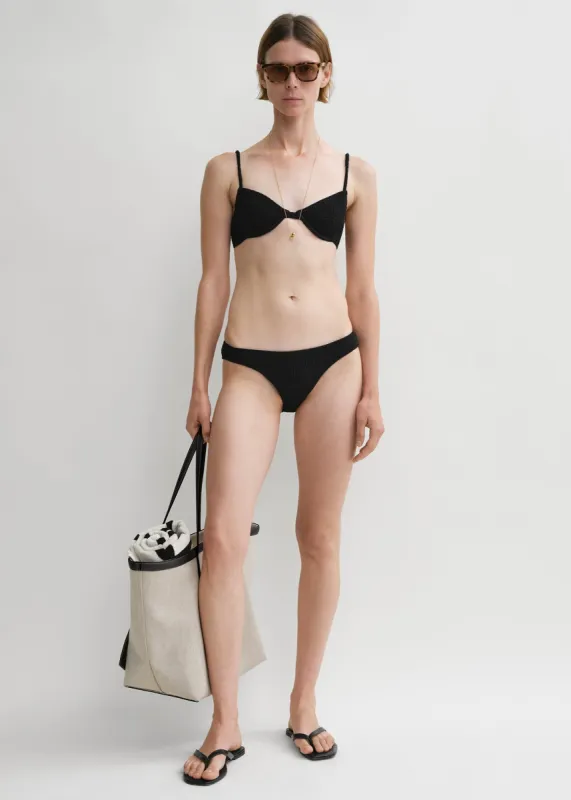 Smocked half-cup bikini top black sold by Toteme