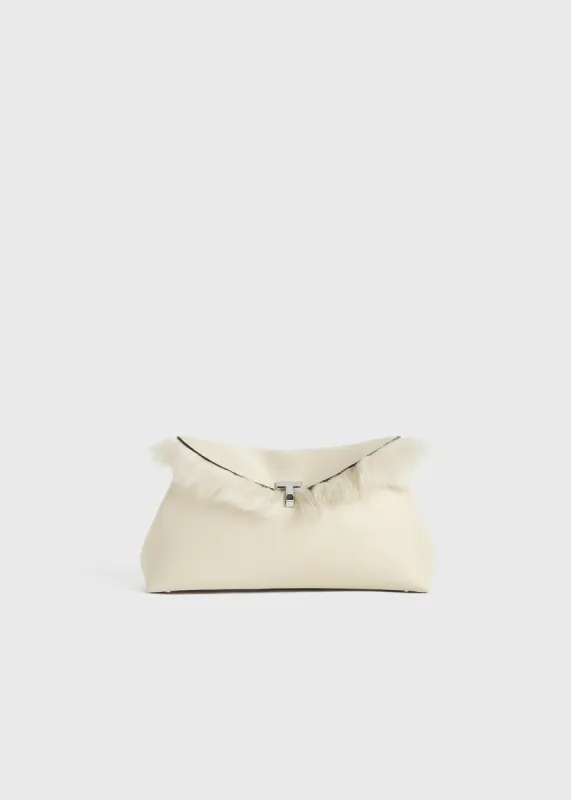 Shearling T-lock clutch ecru sold by Toteme