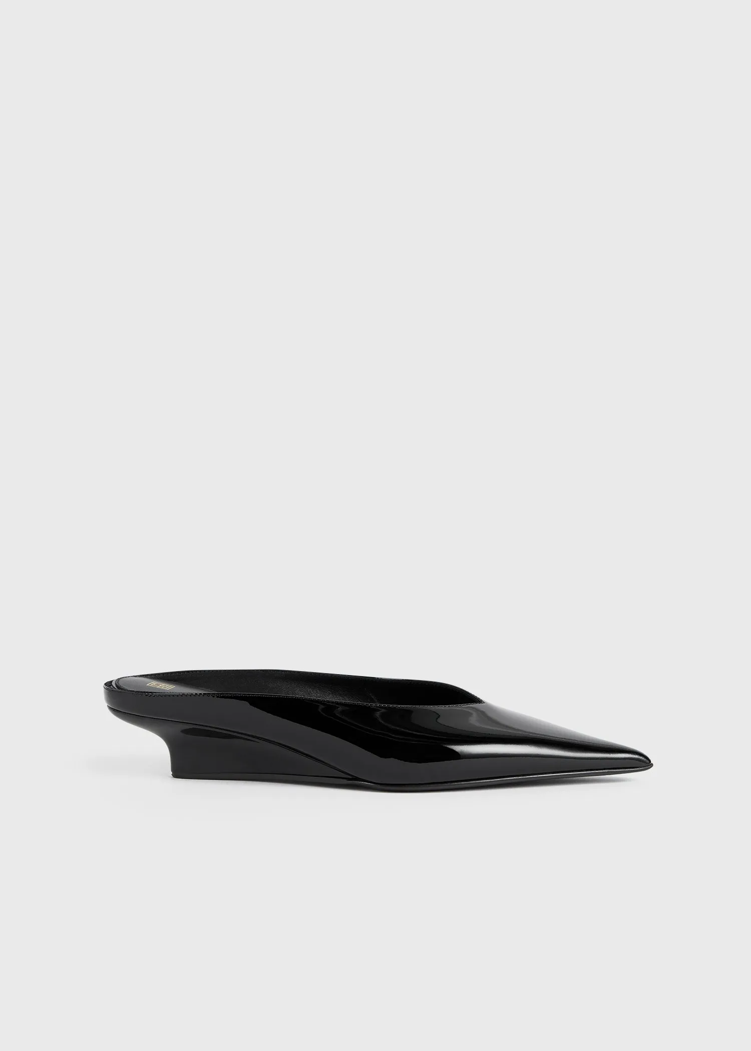 Sharp patent wedge mules black sold by Toteme