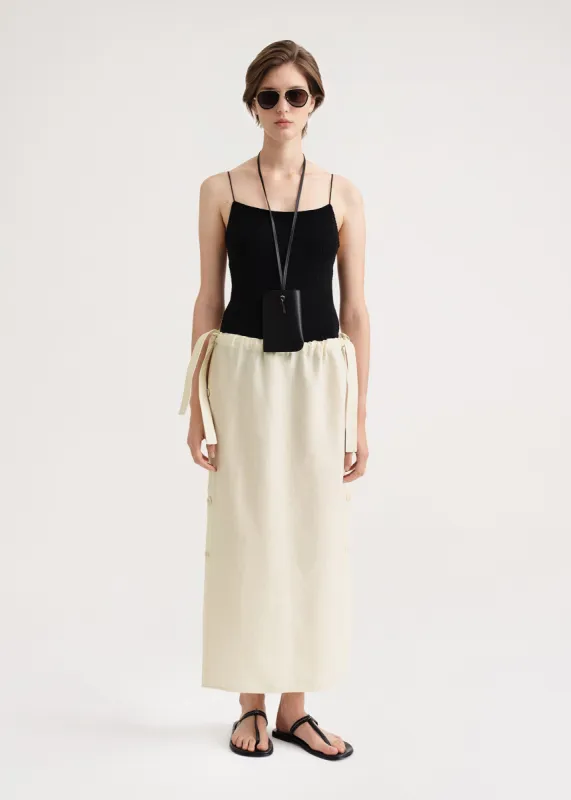 Side button drawstring skirt vanilla sold by Toteme