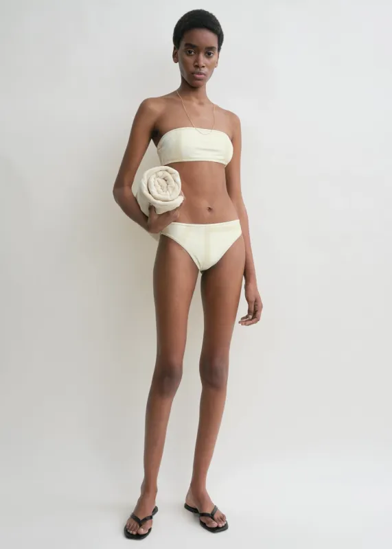 Monogram strapless bikini top ecru/straw sold by Toteme