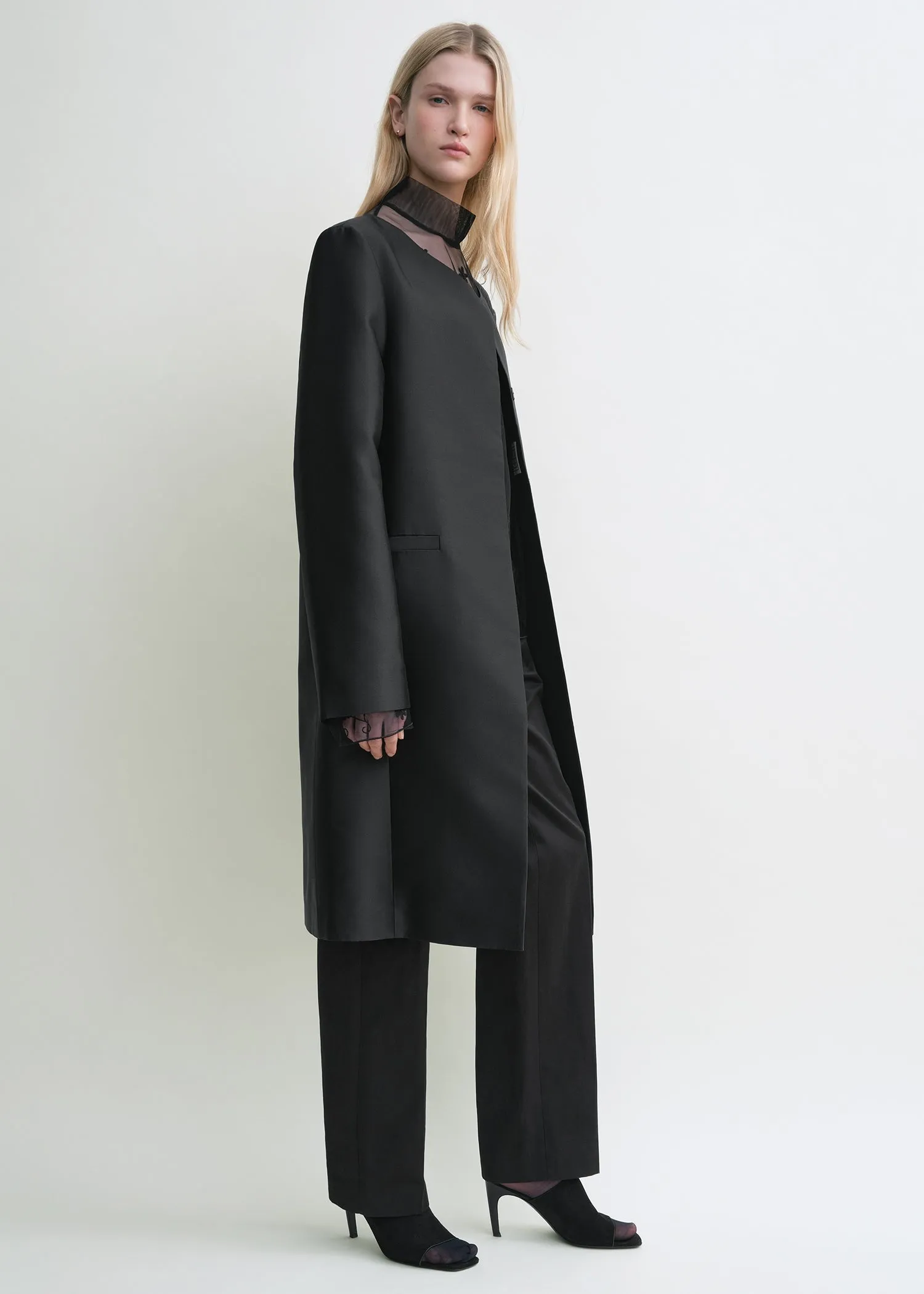 Collarless coat black sold by Toteme
