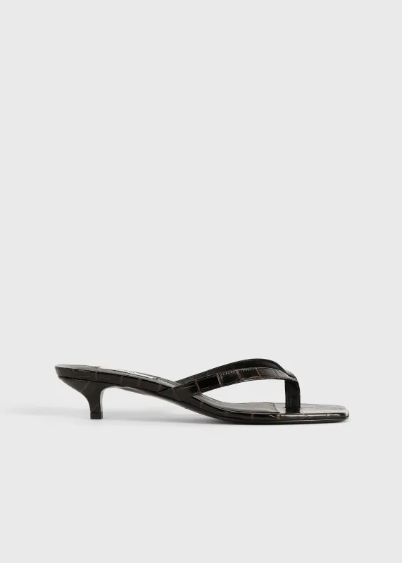 Croco-embossed heeled flip flops dark brown sold by Toteme