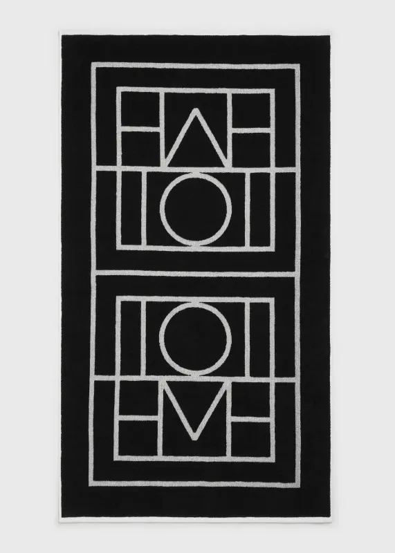 Monogram beach towel black/tofu sold by Toteme