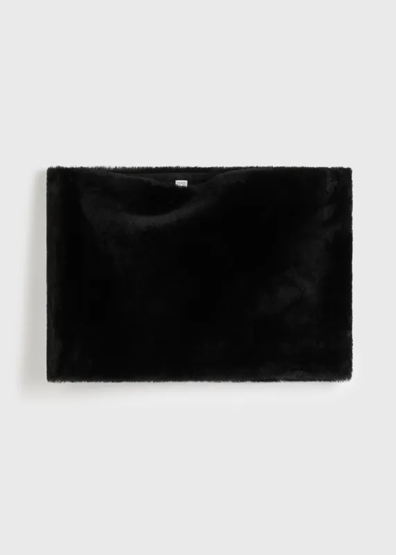 Plush shearling muff black sold by Toteme