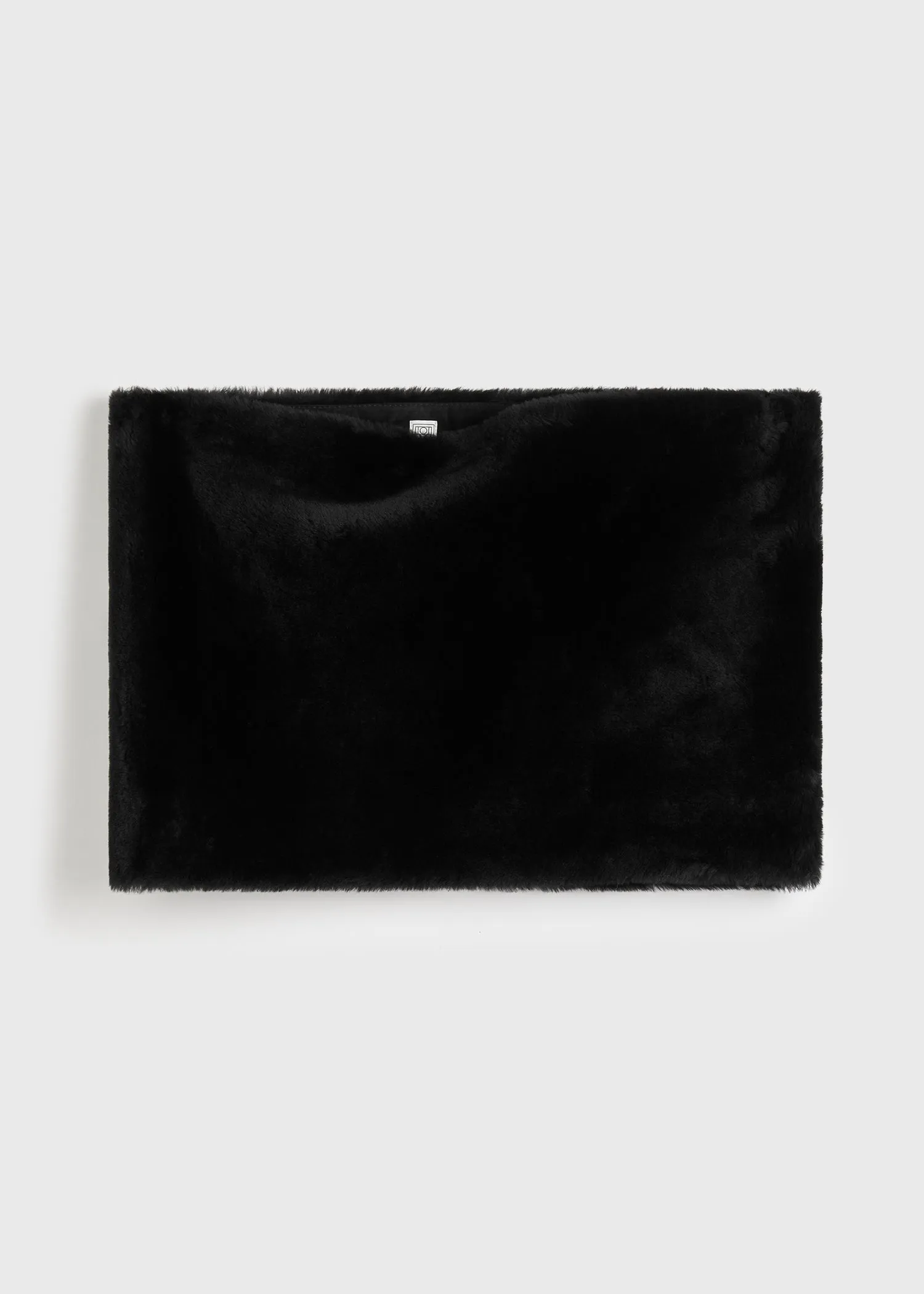 Plush shearling muff black sold by Toteme
