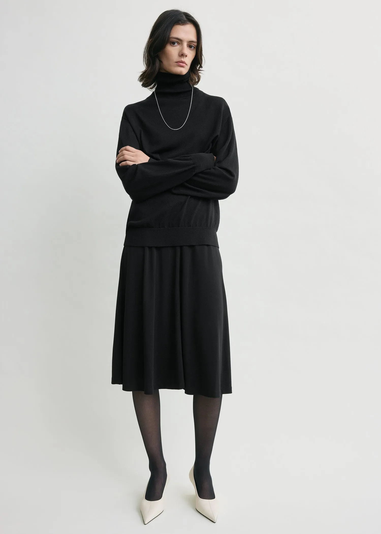 Short fluid jersey skirt black sold by Toteme