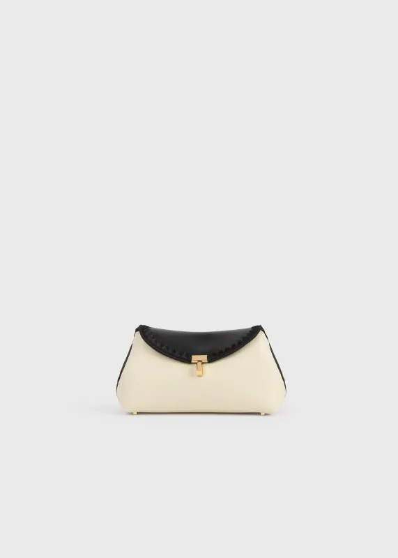 Mini T-lock embroidered leather clutch black/milk sold by Toteme