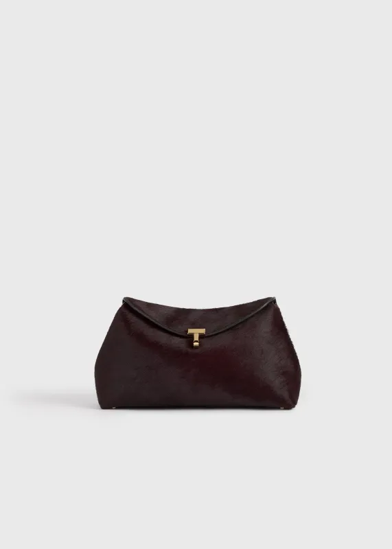 T-lock pony hair clutch wine sold by Toteme