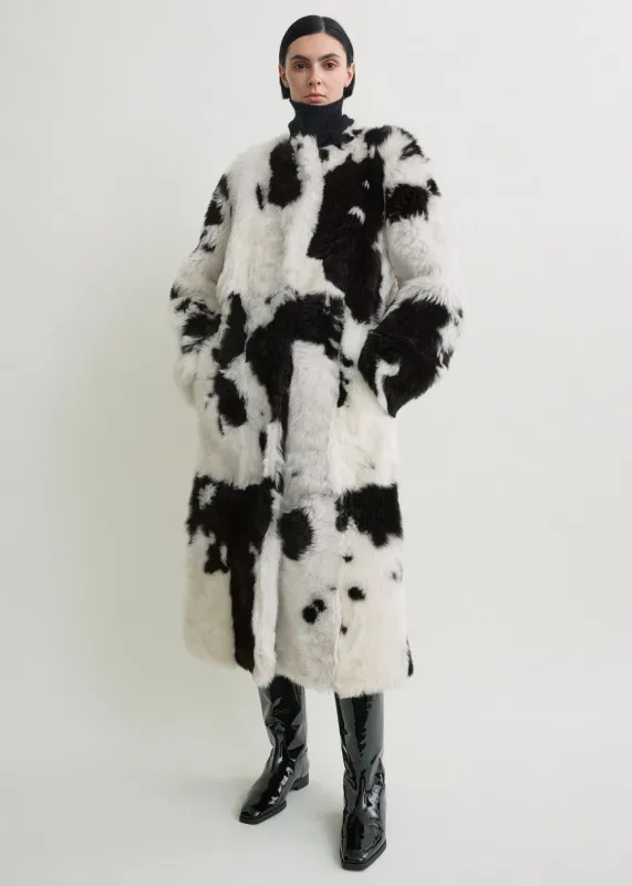Monochrome shearling coat black/white sold by Toteme