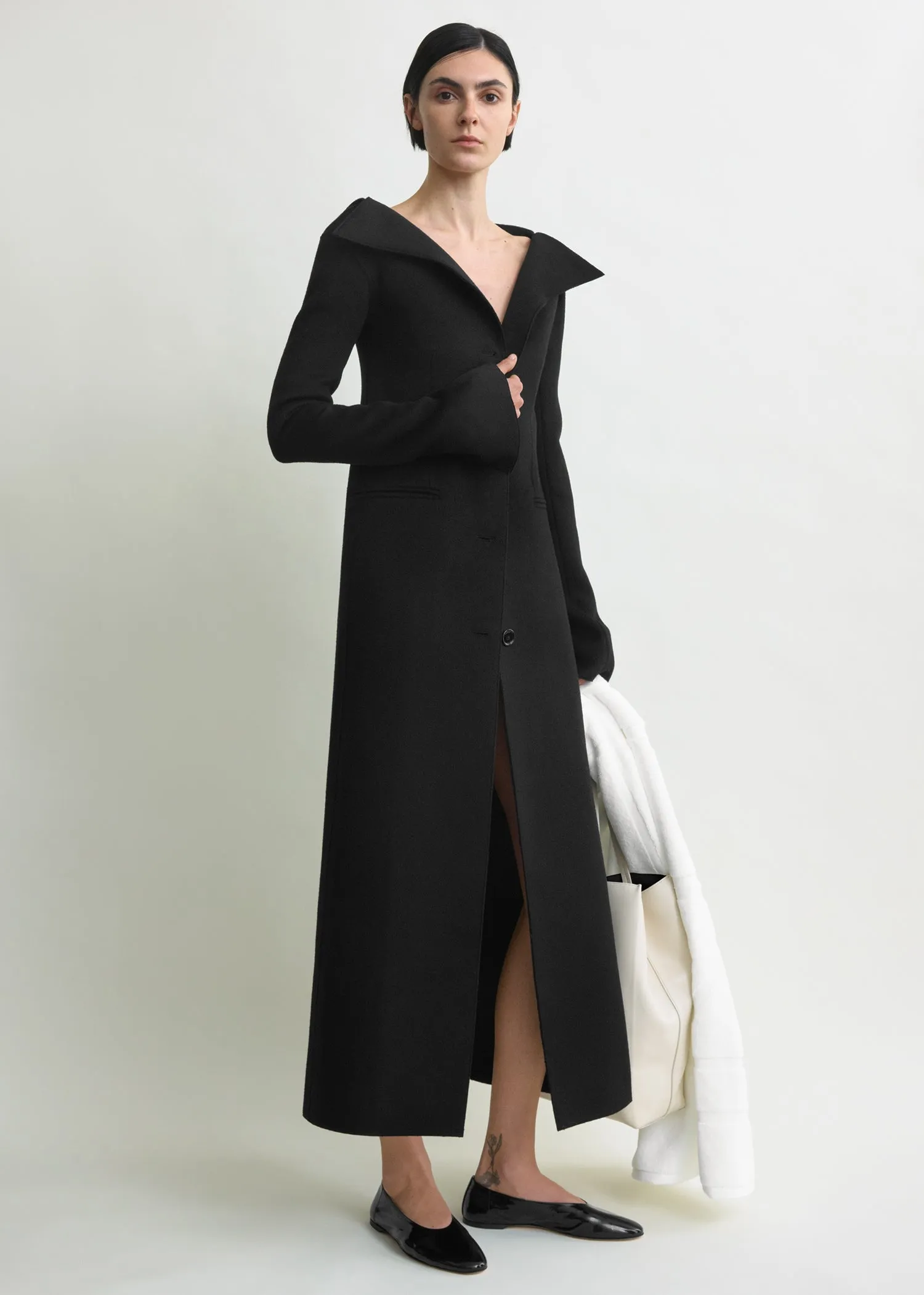 Open collar wool coat black sold by Toteme