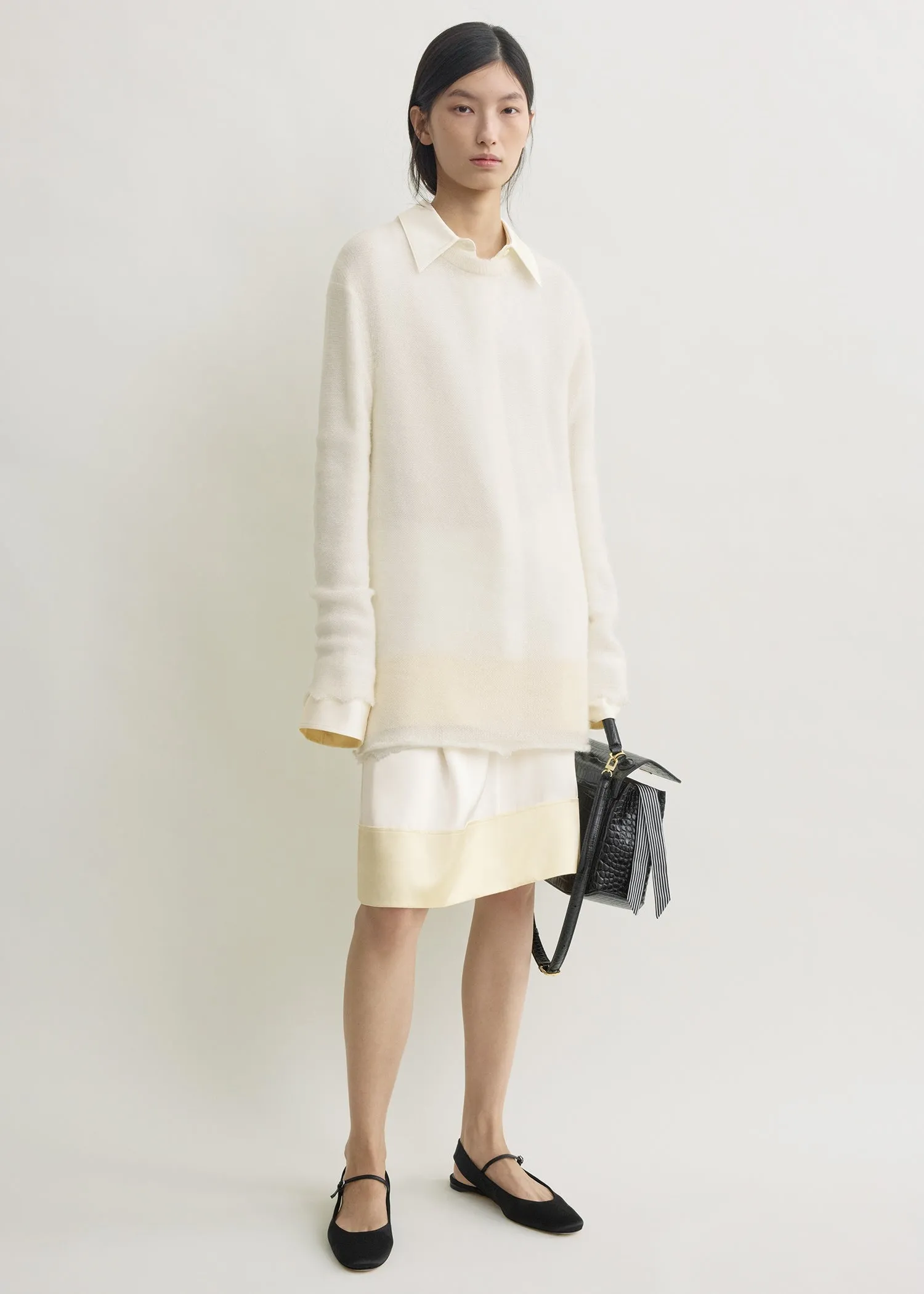 Long open weave knit off-white sold by Toteme