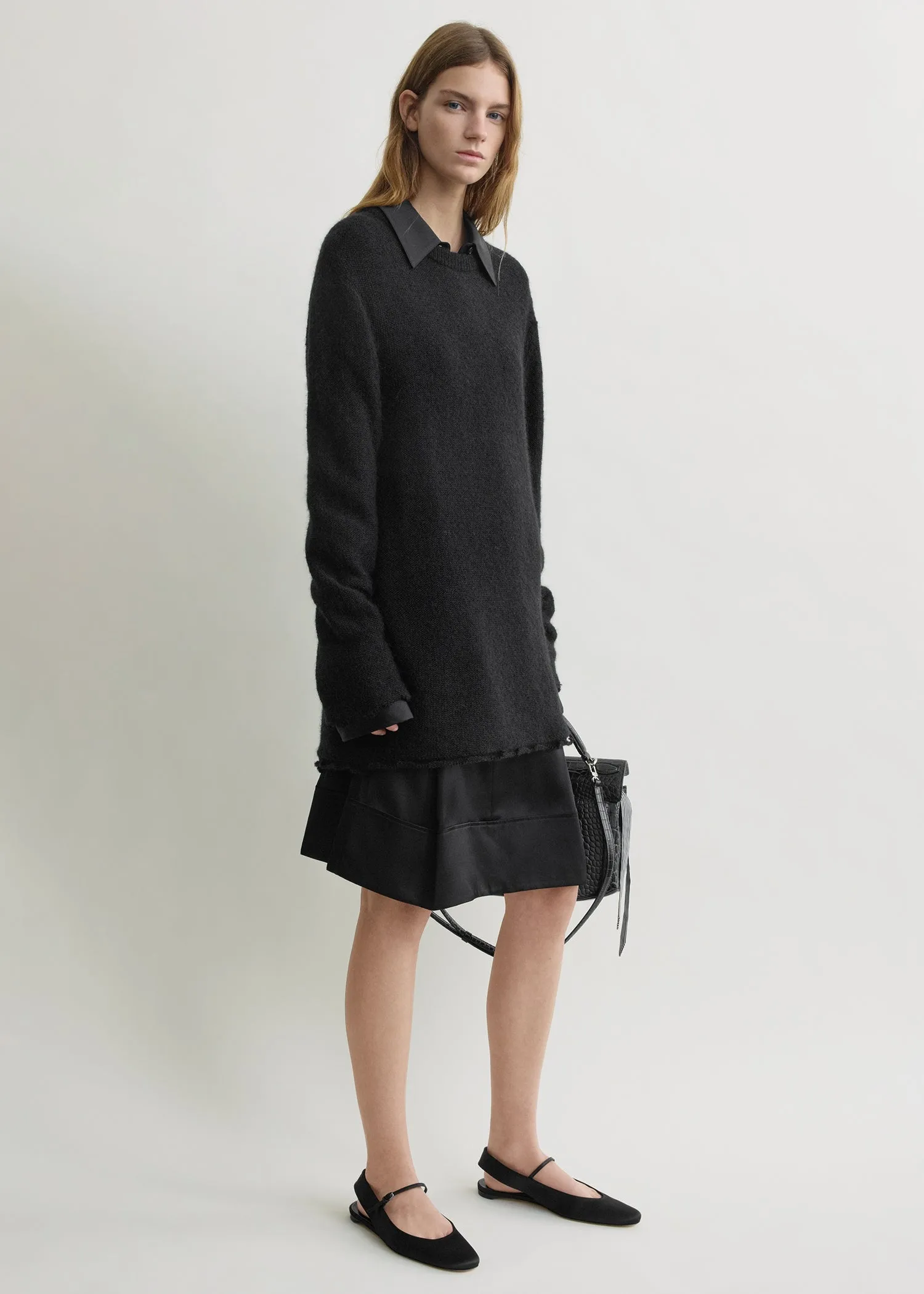 Long open weave knit black sold by Toteme