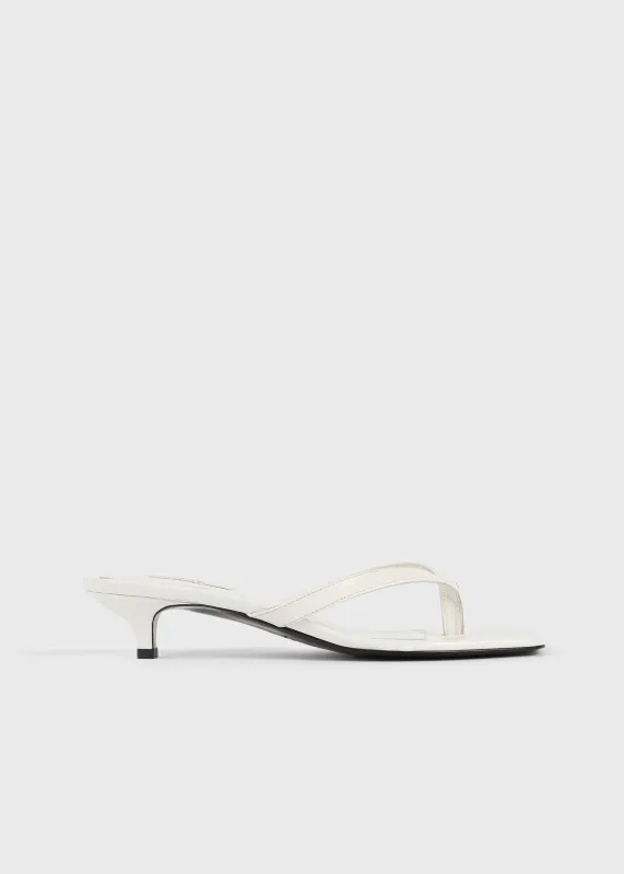 Croco-embossed heeled flip flops off-white sold by Toteme
