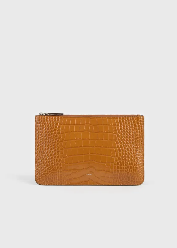 Threefold croco-embossed clutch tangerine made by Toteme