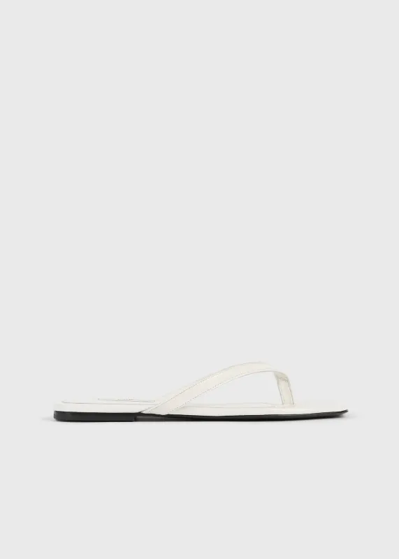 Croco-embossed flip flops off-white sold by Toteme